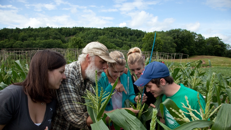 Scott P. Stokoe with students and corn
